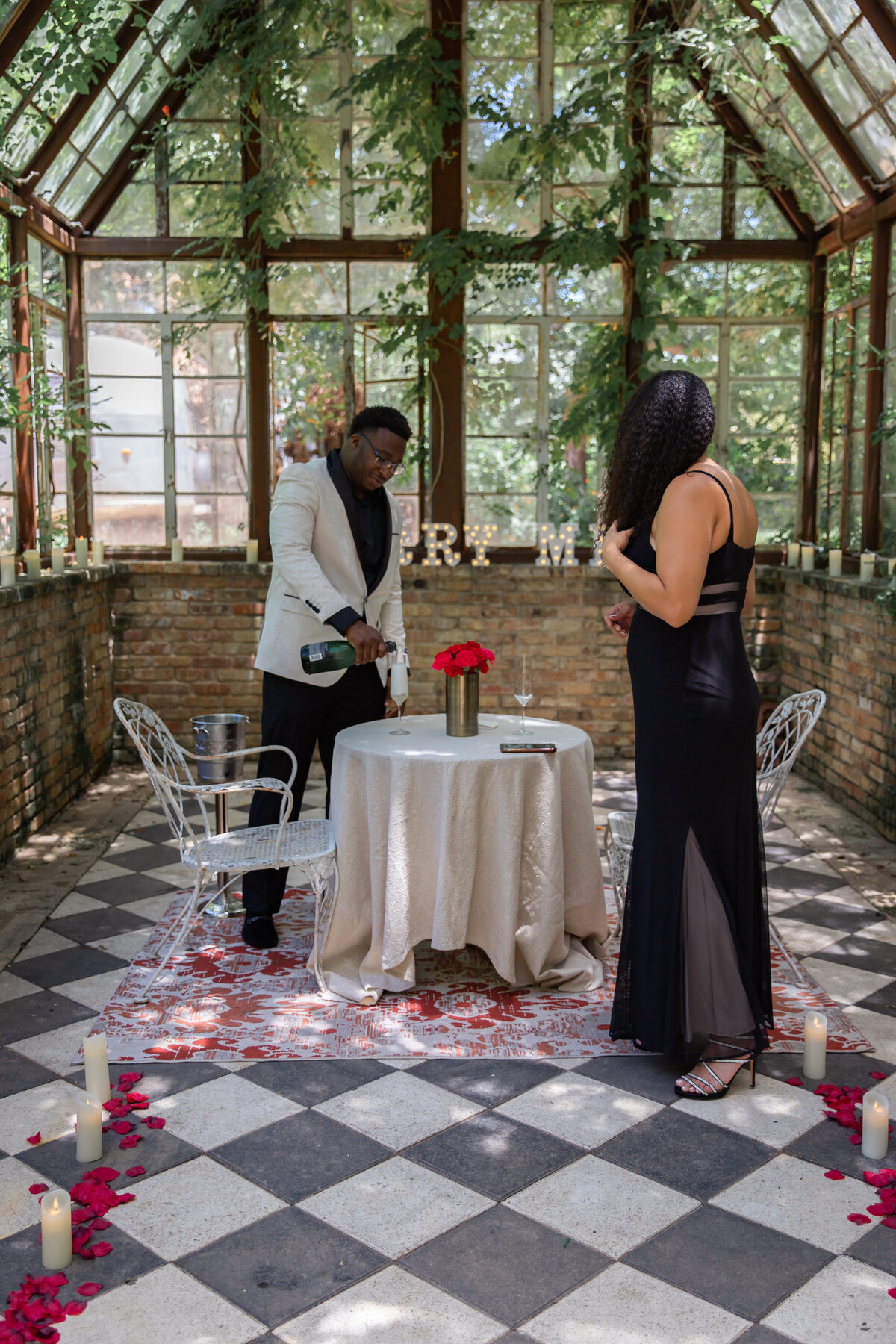 How to plan a proposal in Austin man pouring champagne