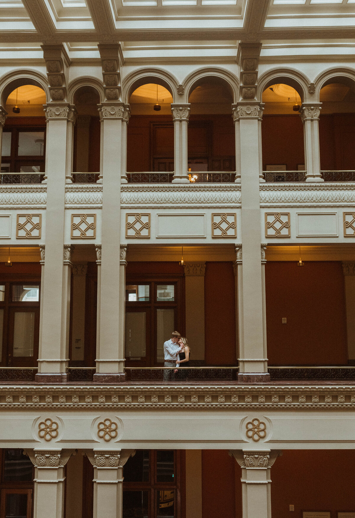 A modern, classy winter engagement session in Minneapolis, Minnesota exploring  the halls of a historical  landmark center