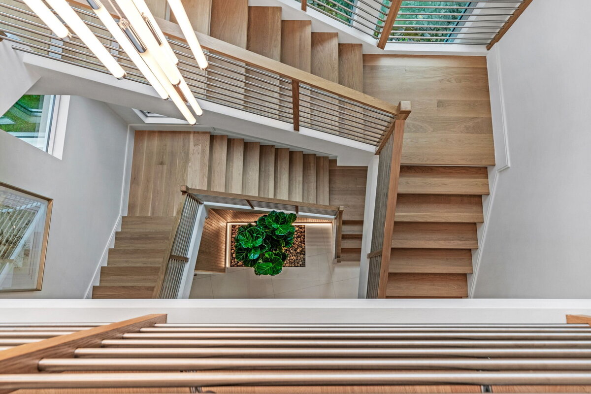 3 story open staircase designed by Gracious Home Interiors