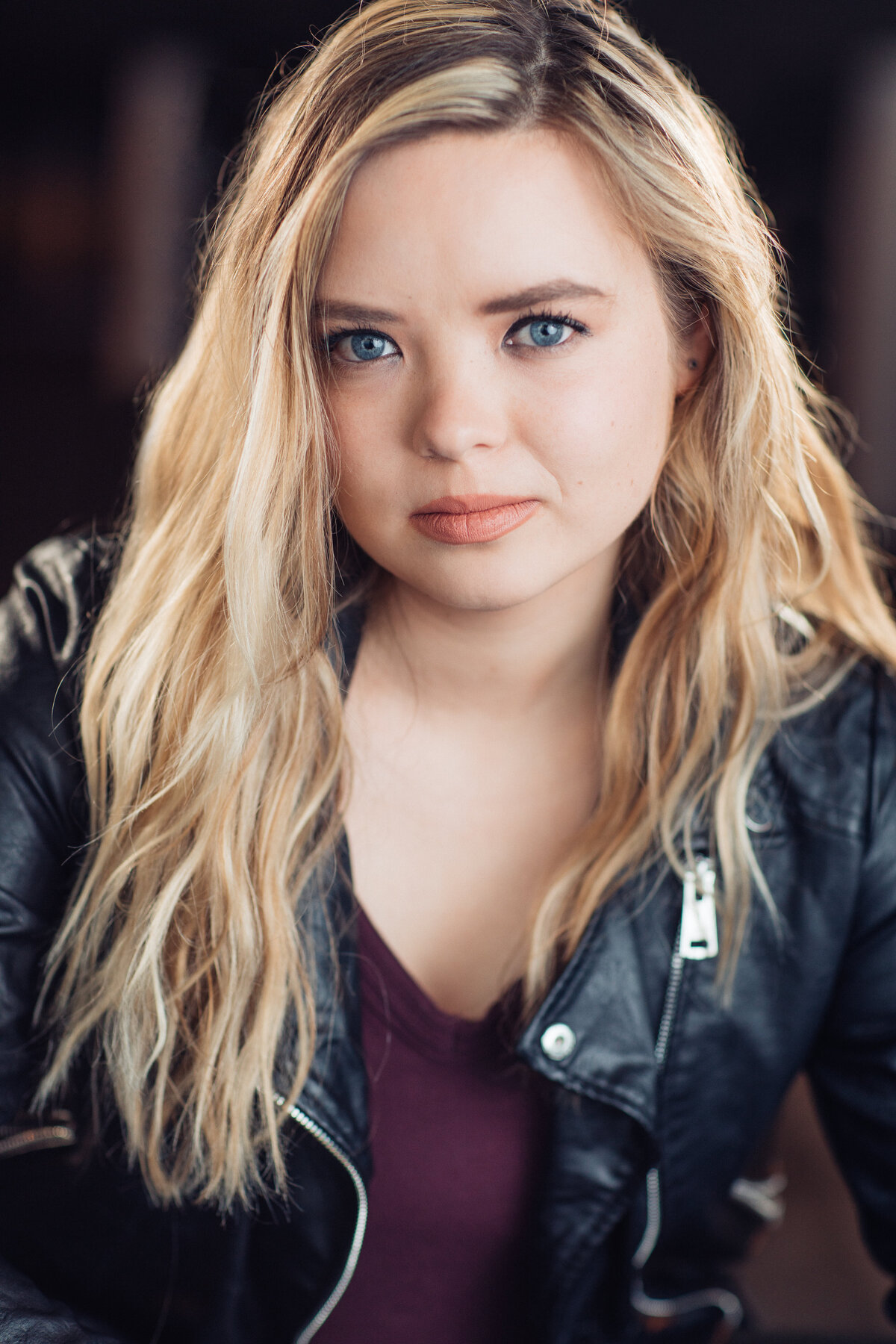 Headshot Photograph Of Young Woman In Black Leather Jacket And Inner Violet Shirt Los Angeles