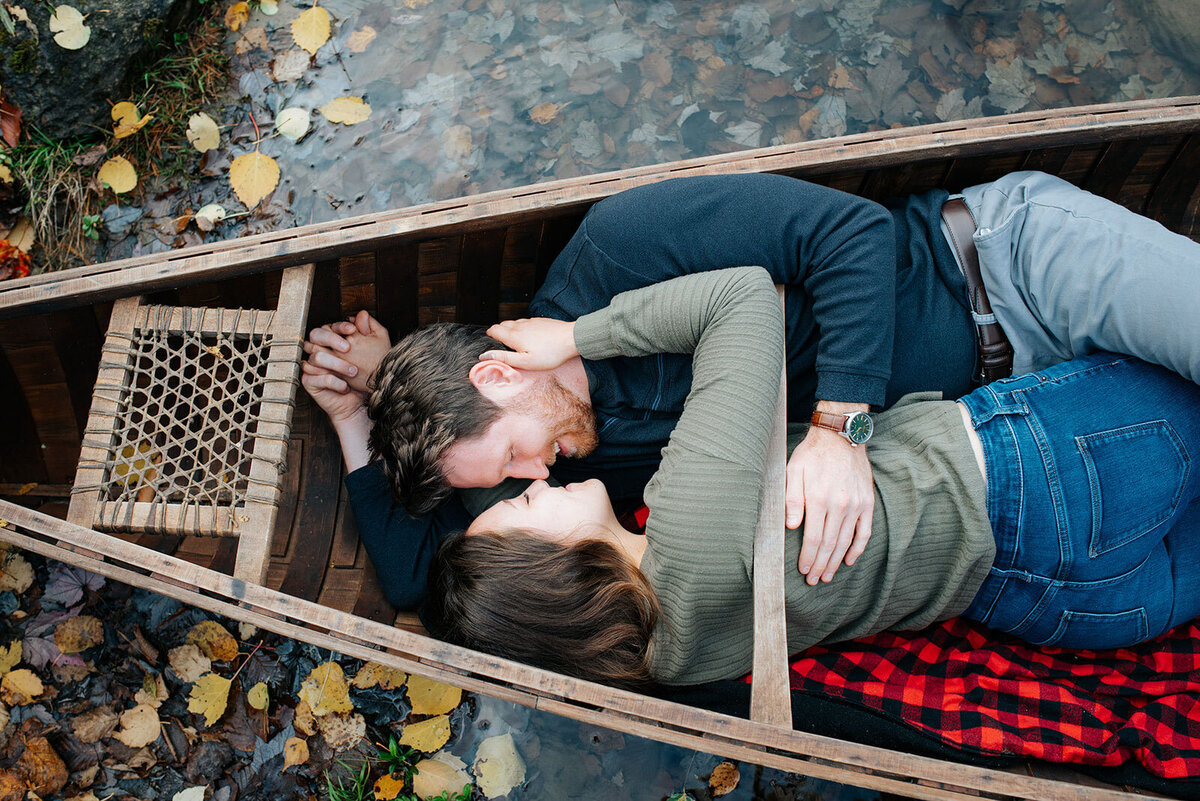 couple kissing in canoe fall leaves chittenden vermont