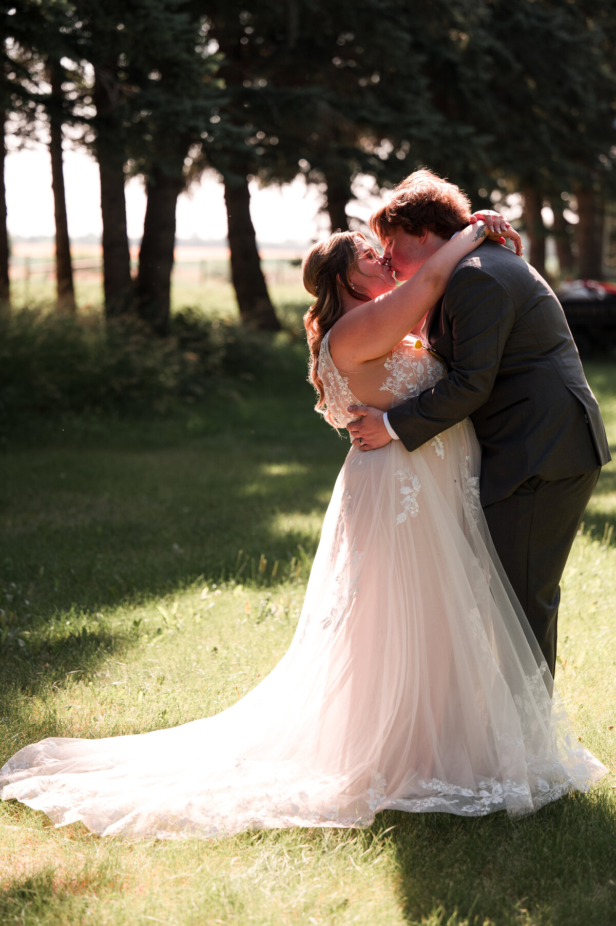 Bride and groom kissing in wedding photo