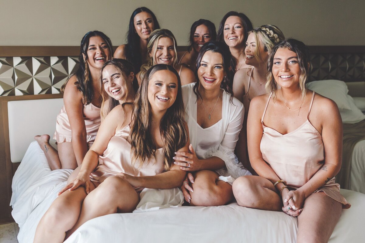 Bridesmaids on bed with robes at Hyatt Ziva Cancun
