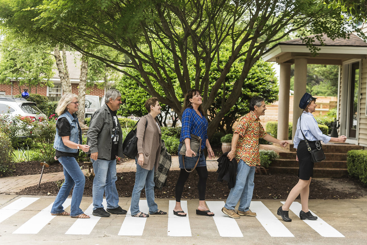 Guests pose on  Abbey Road at a Beatle's themed birthday party