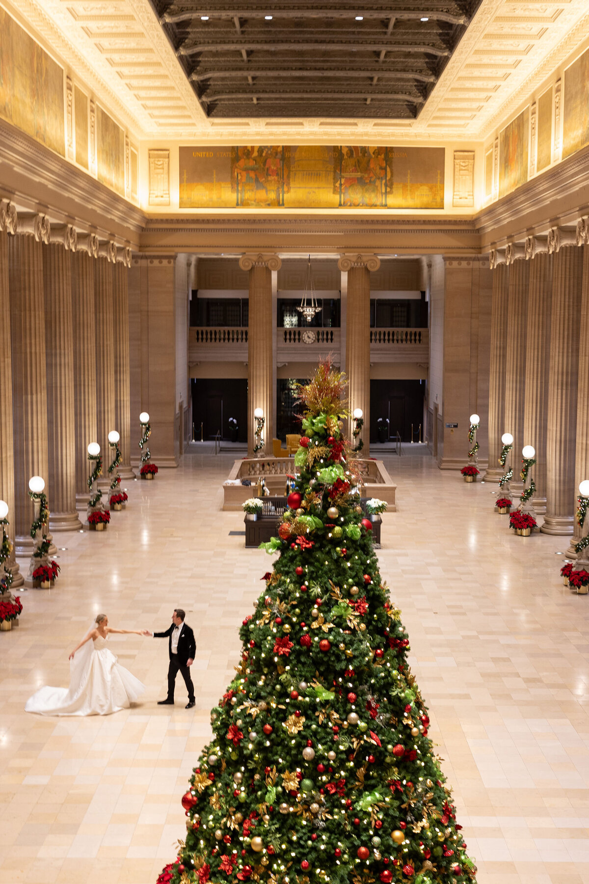 The bride and groom dancing in the Palmer House next to the christmas tree.  Chicago.