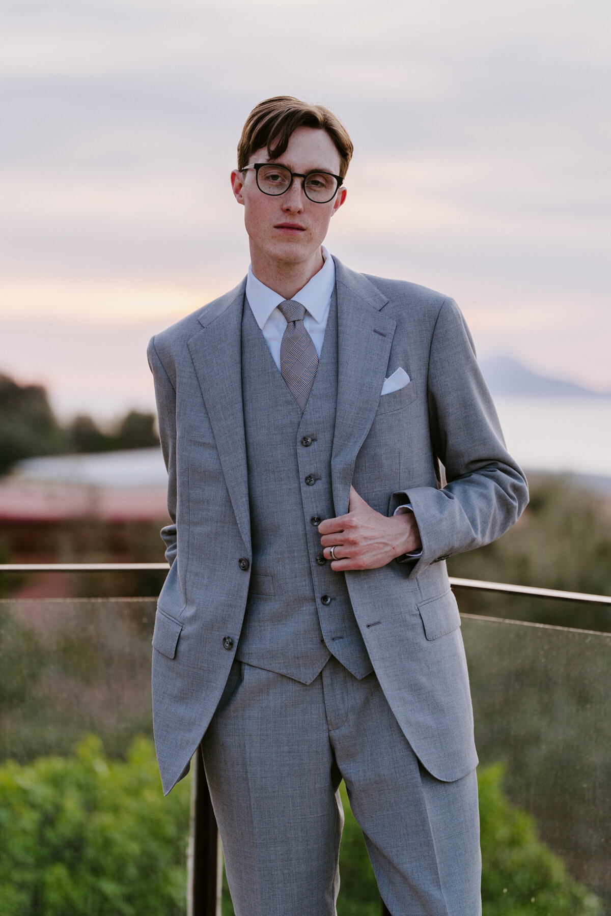 Groom standing on terrace overlooking Sorrento