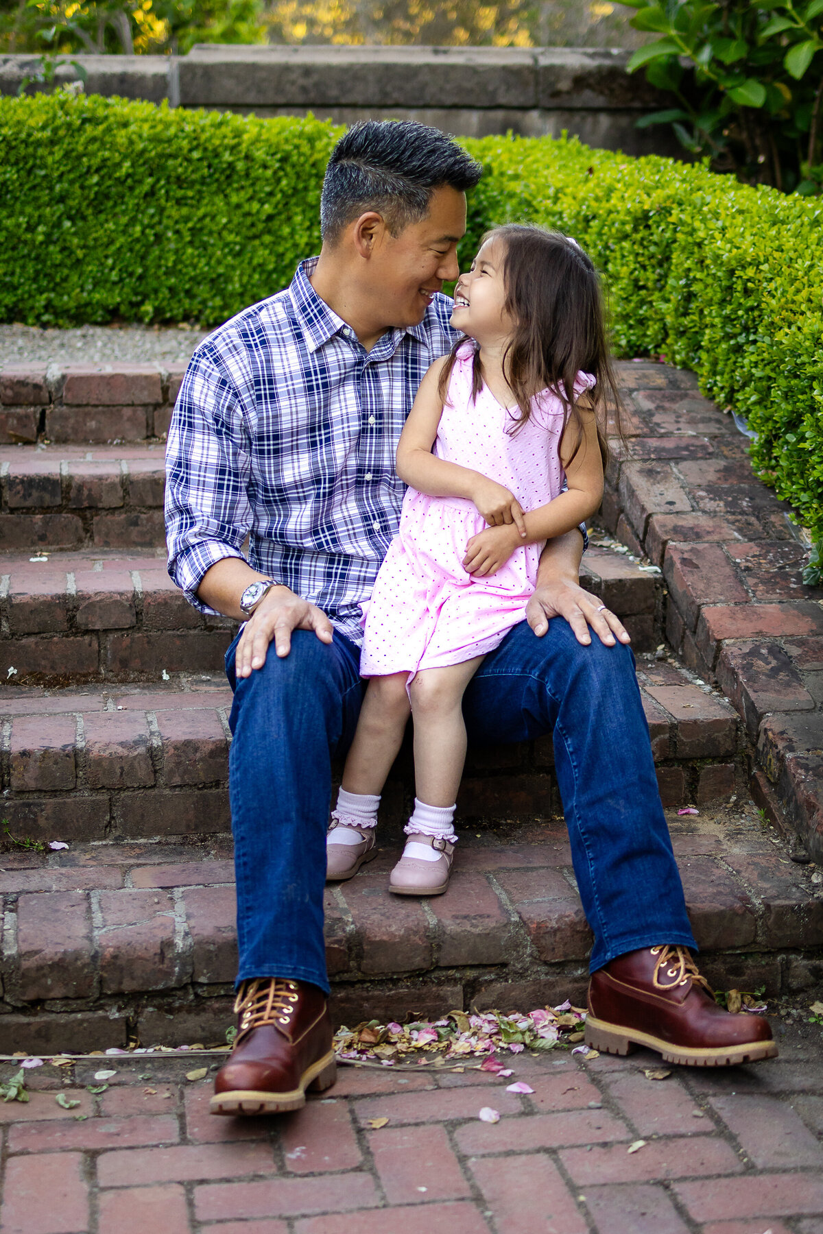 kohl mansion Burlingame father  hugging daughter while laughing together in a vibrant rose garden – playful sibling photography by Ellobelle Photography, serving the San Francisco Peninsula