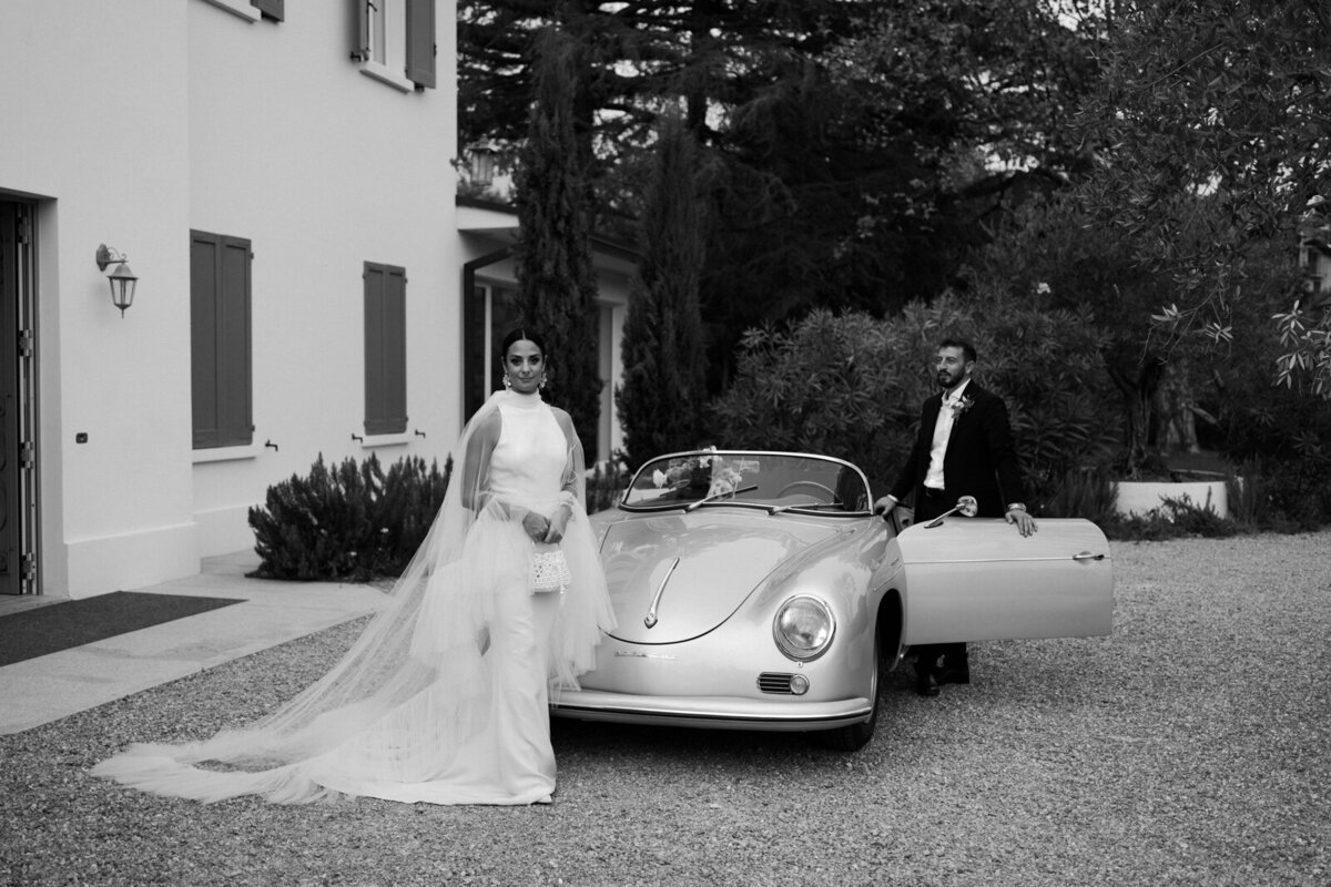 wedding couple doing portraits on a vintage luxury car in Italy