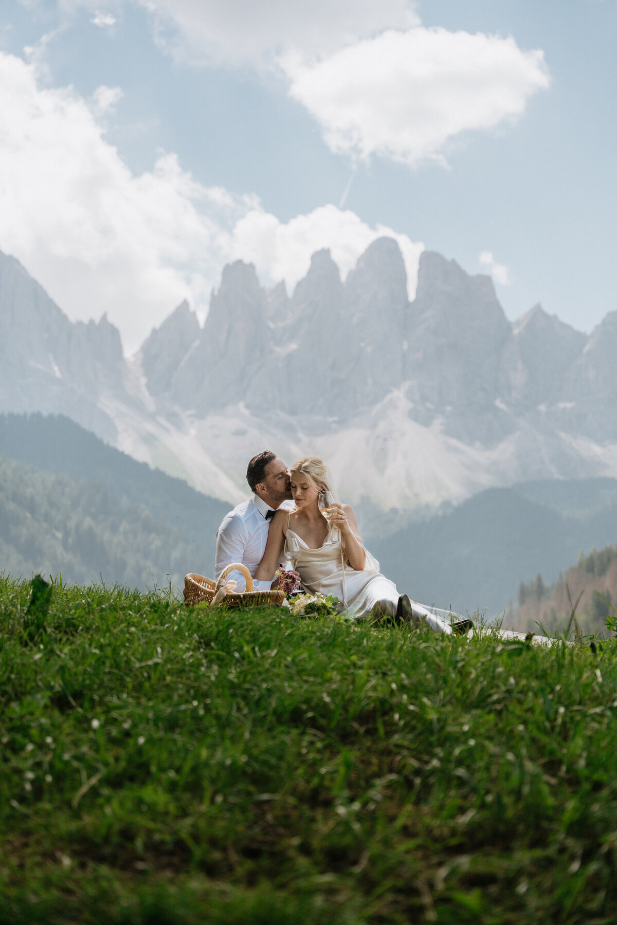 Scenic view of Dolomites peaks behind bride and groom