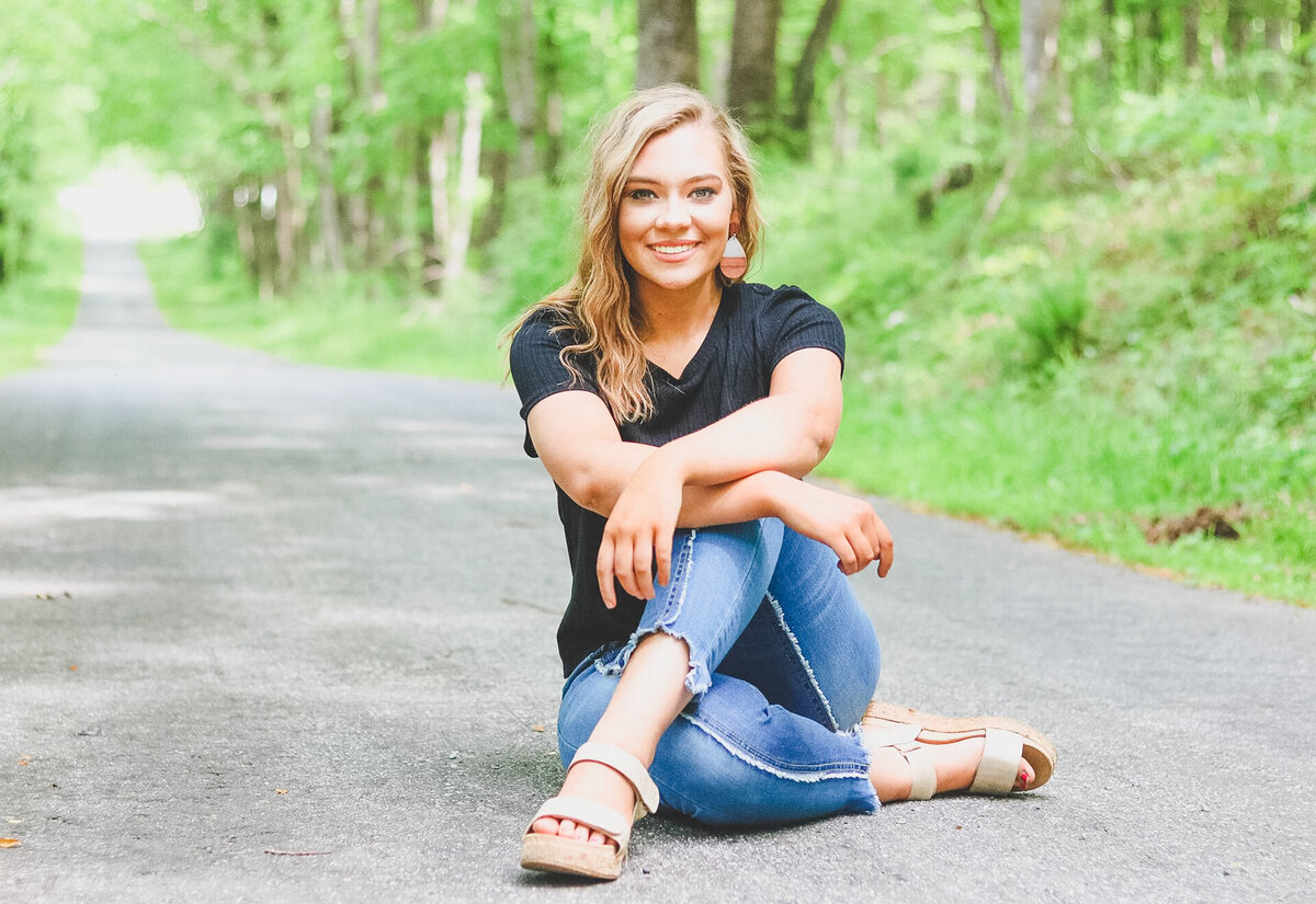 Senior girl sitting in road