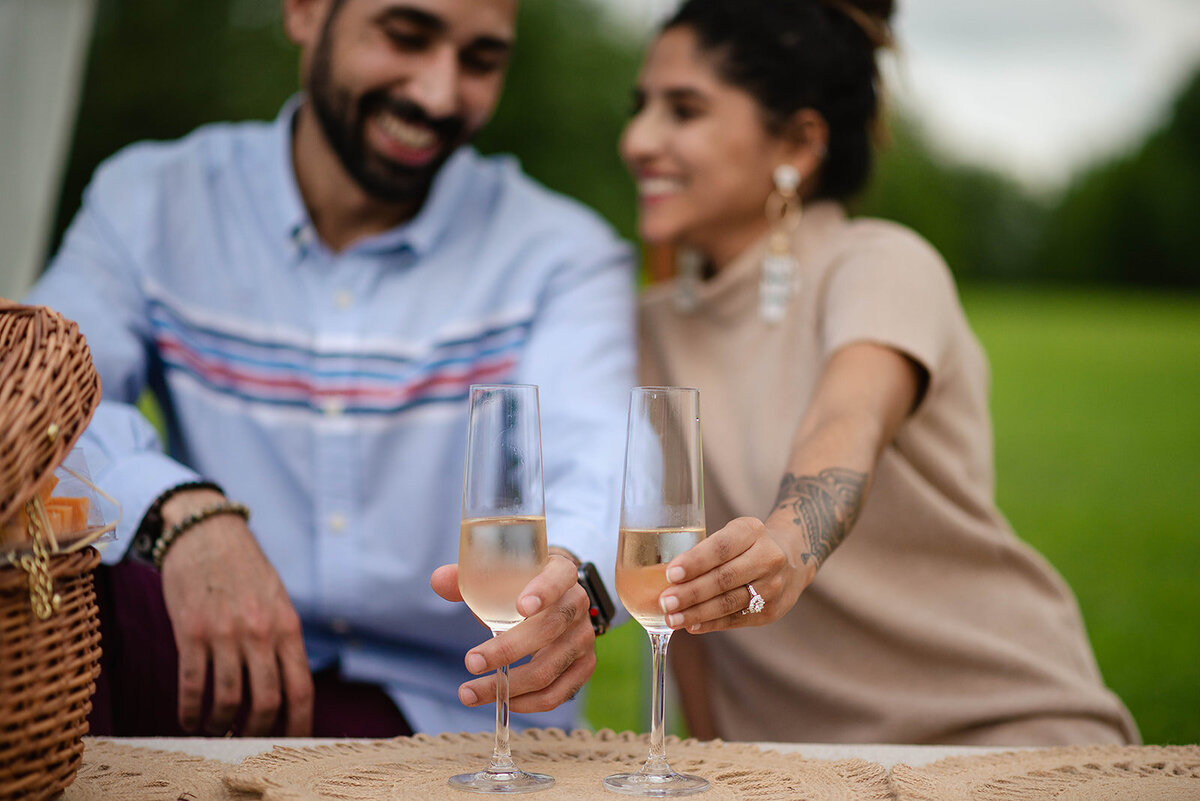 Where to propose in Austin couple clinking glasses of champagne