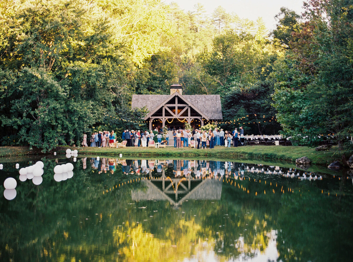 Fall wedding at Blackberry Farm. Welcome party for wedding guests at Yallerhammer Pavilion on property at Blackberry Farm. Growing floral installation with whimsical florals for entrance to reception. Rustic and earthy floral design with elegant notes of blush and cream. Wildflower design in ikebana style with glowing candlelight reception tables. Destination wedding at Blackberry Farm. Design by Rosemary & Finch Floral Design in Nashville, TN.
