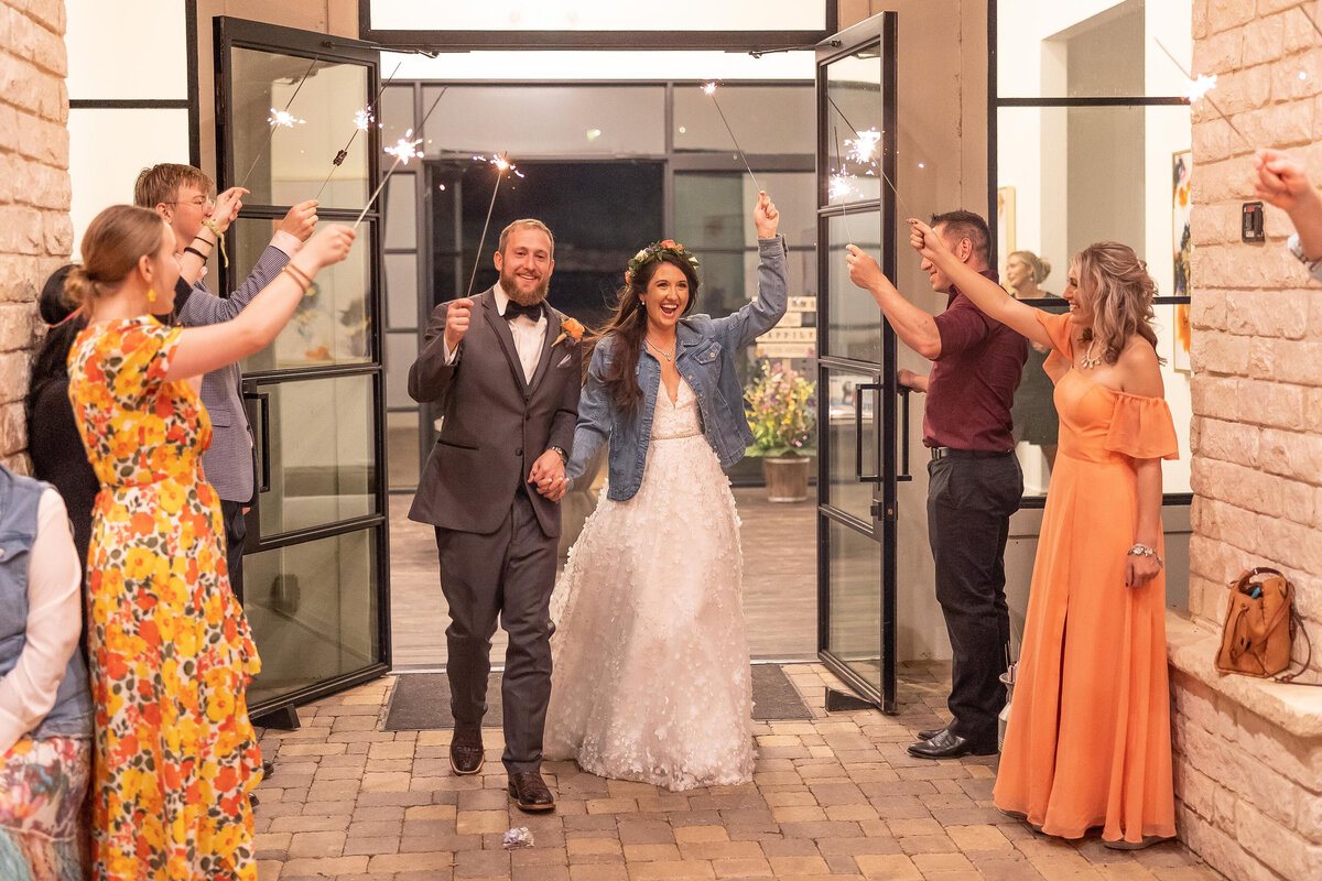 bride and groom sparkler exit denim jacket on bride