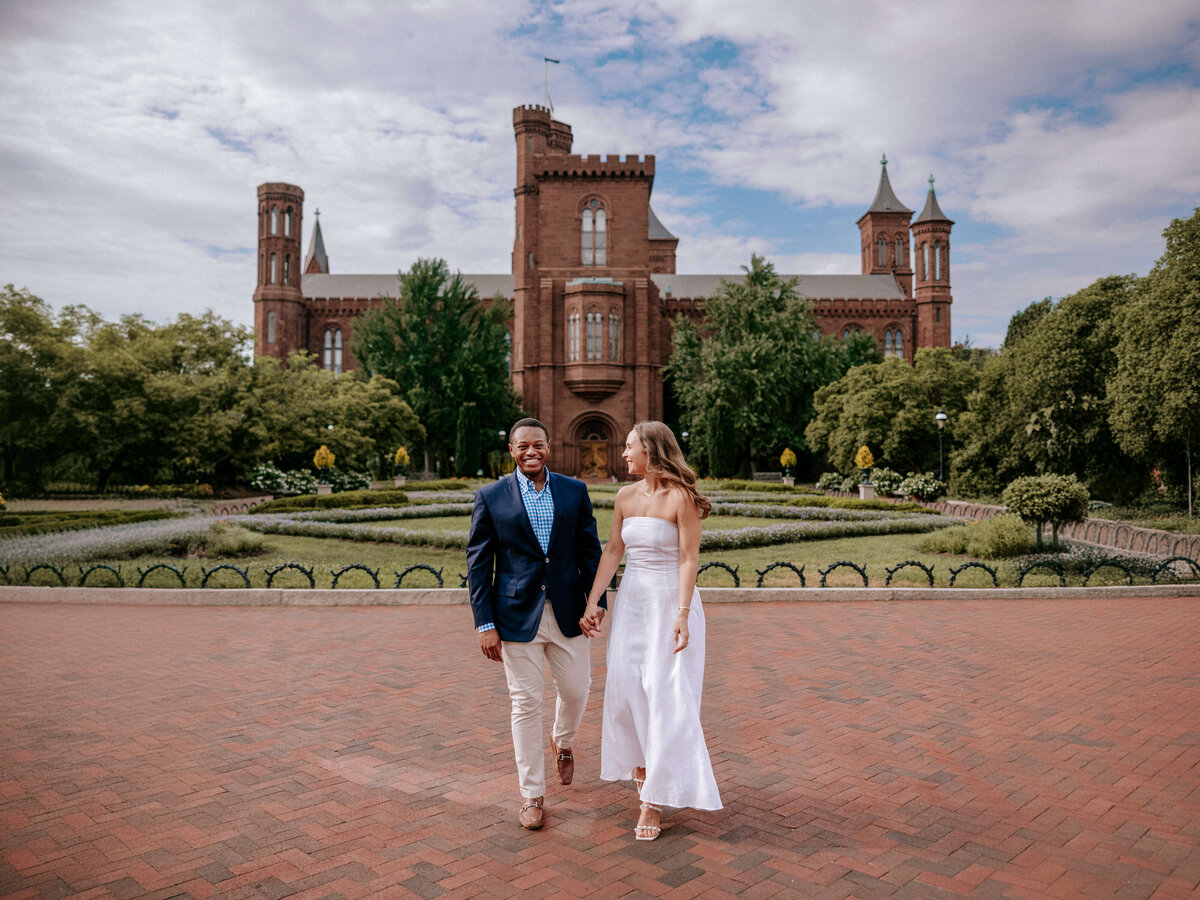 engaged-couple-strolling-near-castle