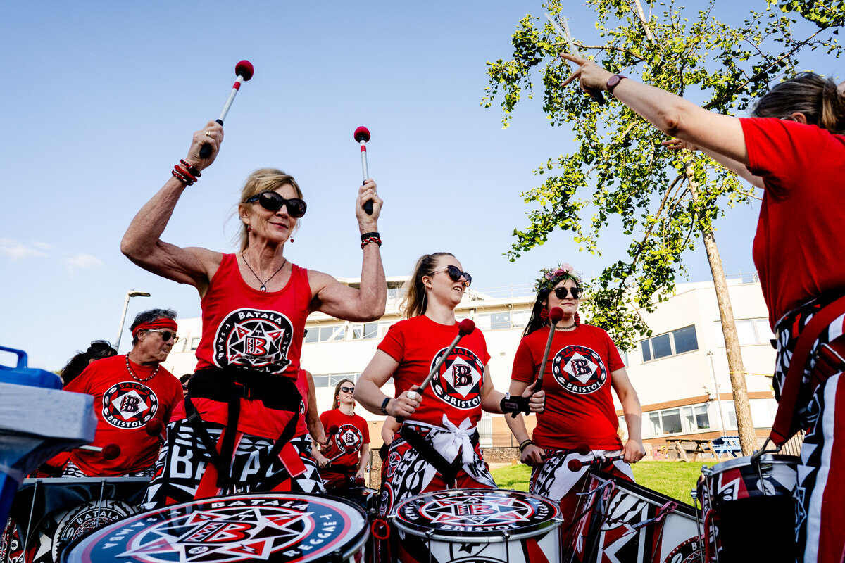 a woman laughing holding the sleeves of her jumper