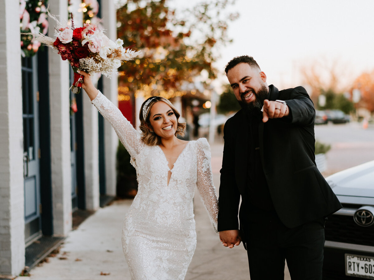 wedding couple excited pointing at camera