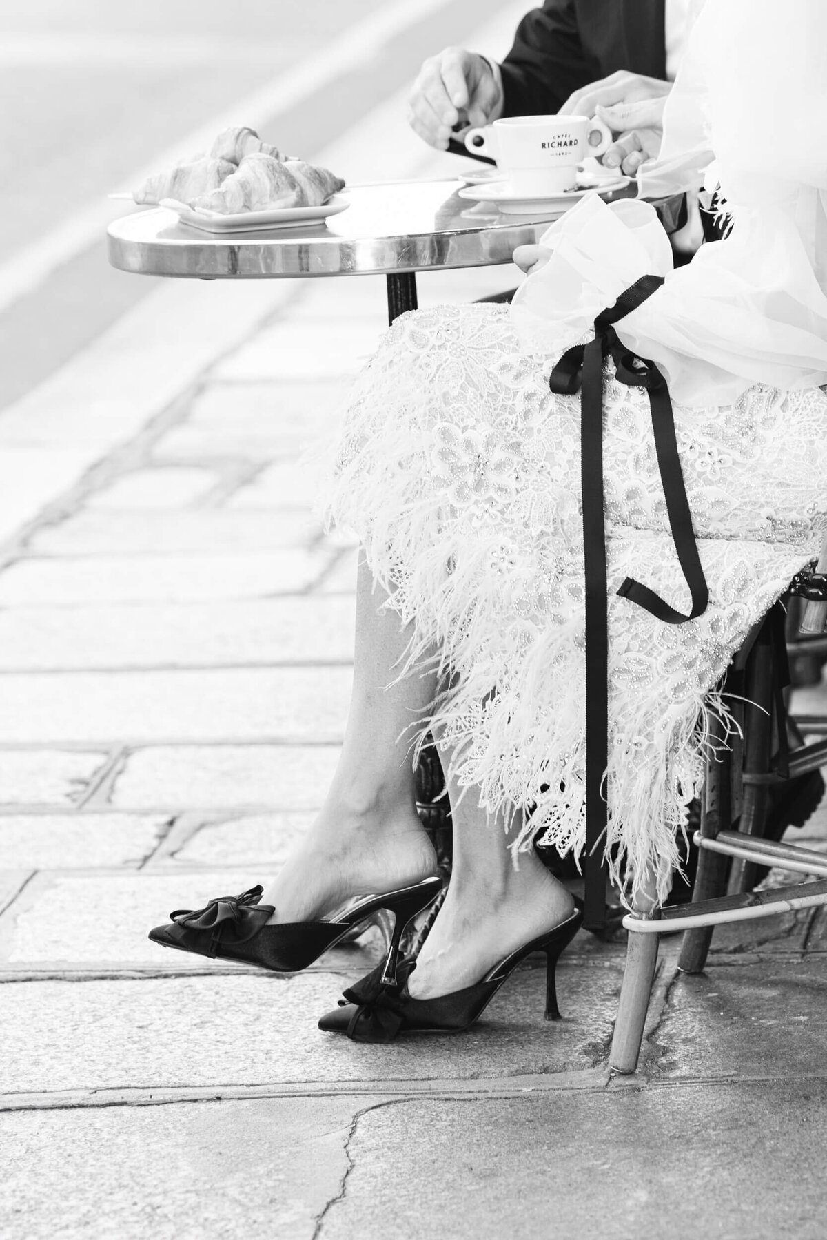 A wedding photo of a bride in her white dress in the streets of Paris in France.
