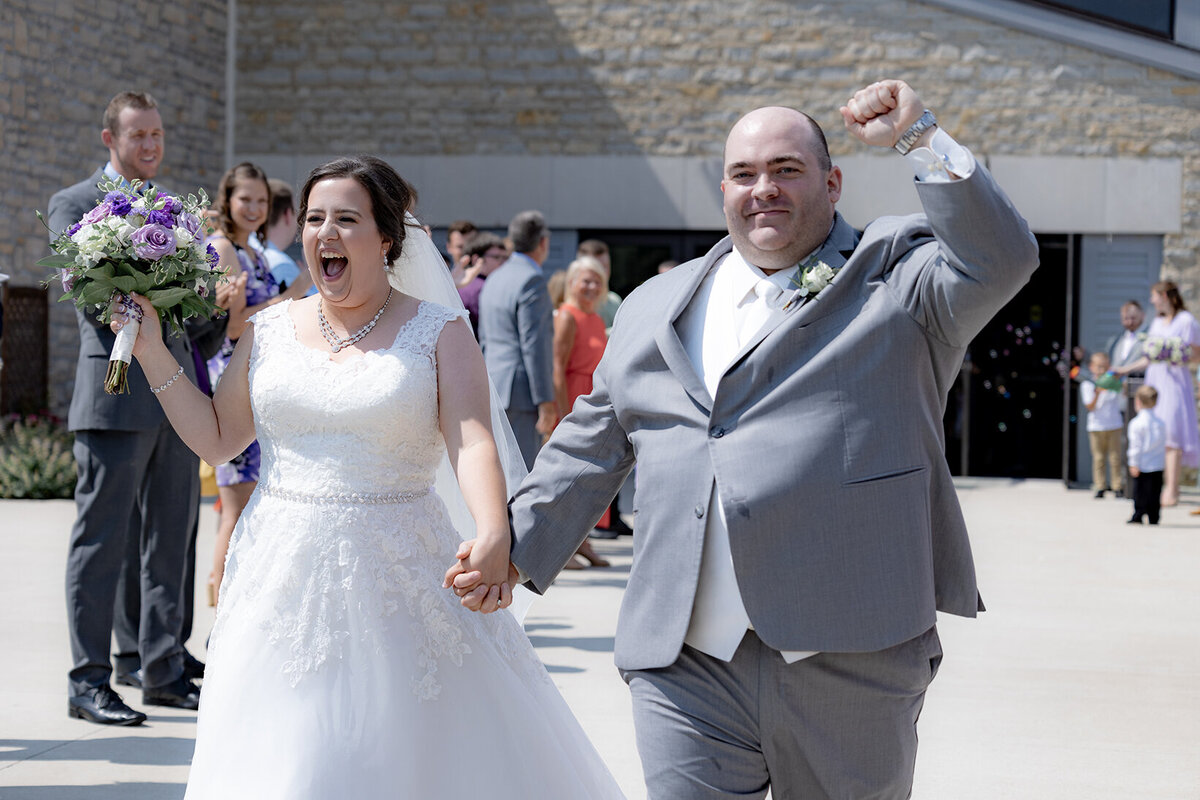 bride-and-groom-celebrate-being-married-during-bubble-exit