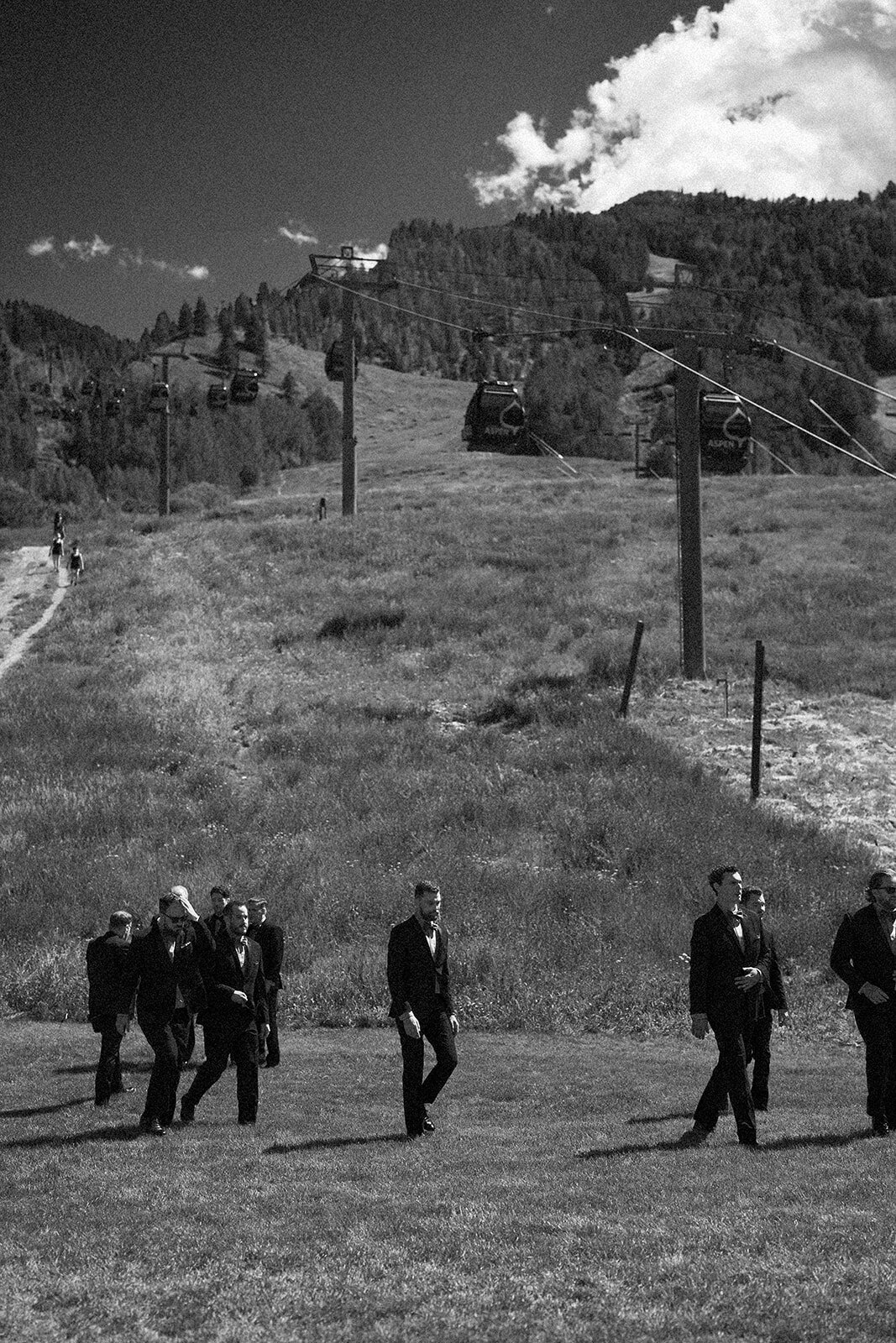 groomsmen-walking under-gondola-black-and-white-aspen-HBICWeddings