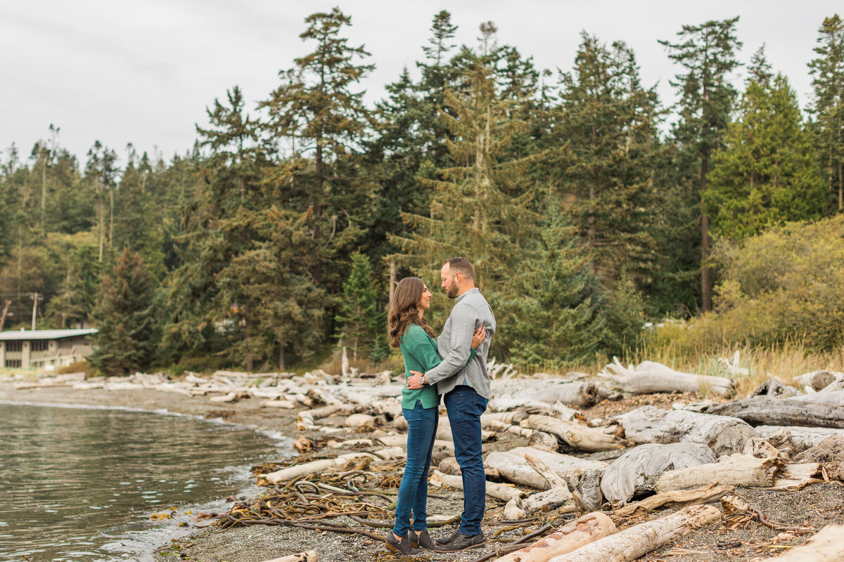 Deception Pass engagement photos near Seattle beach with drfitwood and beautiful PNW trees photo by Joanna Monger Photography