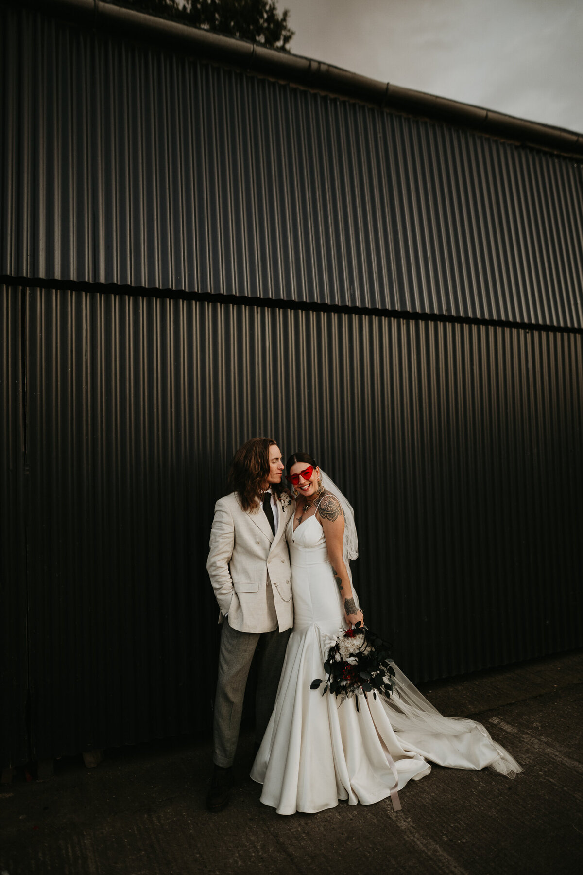 Alternative Wedding Couple outside a black barn.