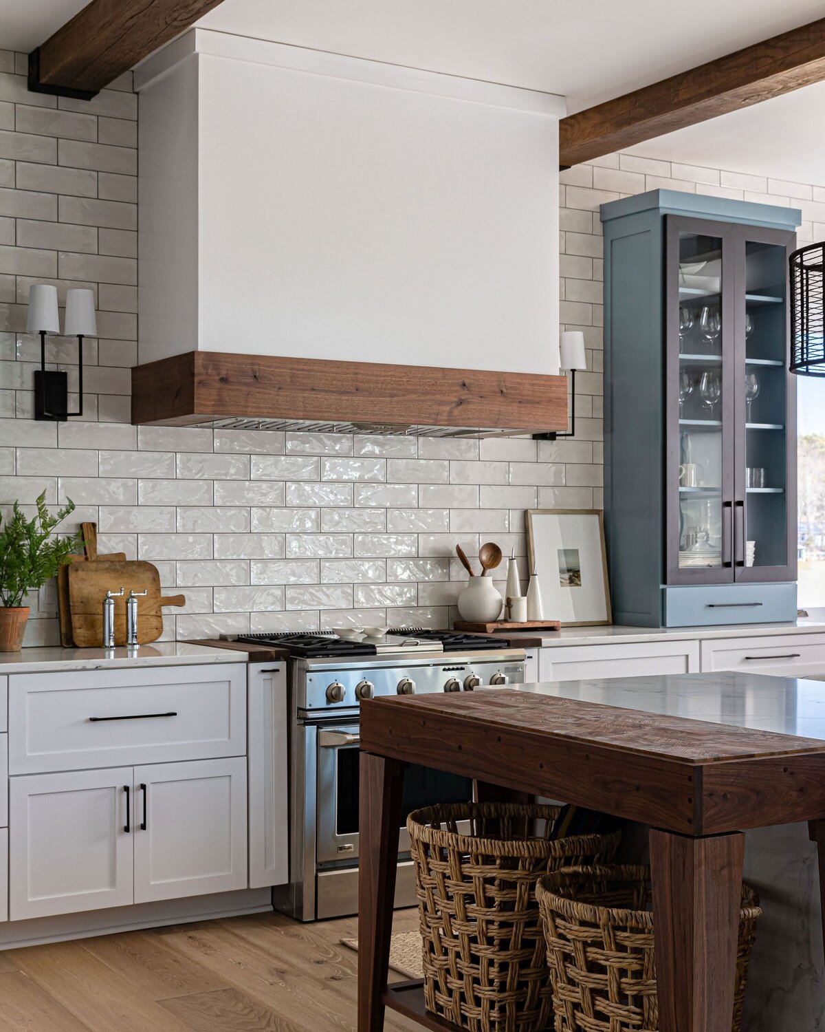 custom built butcherblock table, white and blue kitchen cabinets, white subway tile backsplash