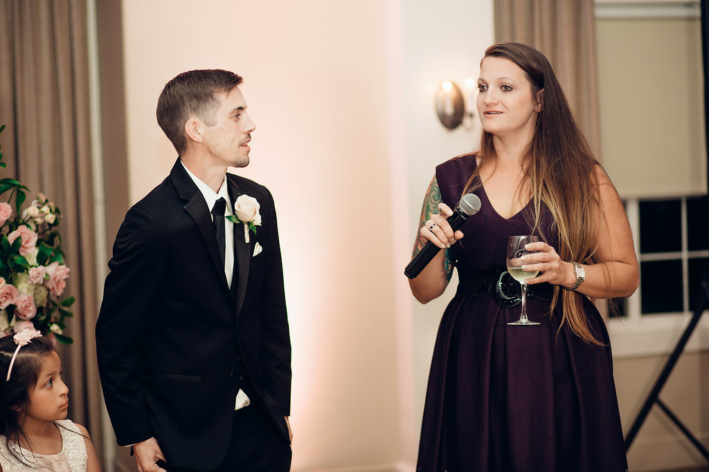 Wedding Photograph Of Groom Looking At The Woman In Violet Dress Speaking Los Angeles