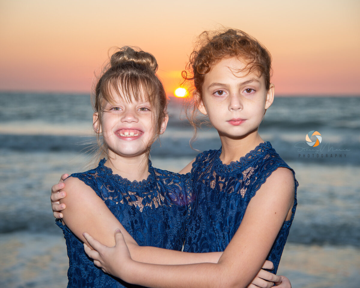 Two new sisters pose in front of the sunset