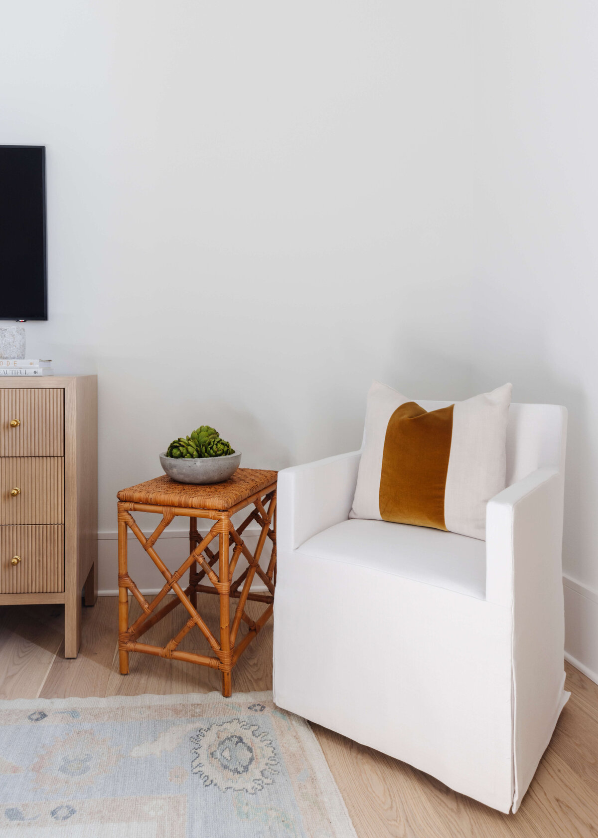 oyster creek studios hughes white accent chair with wooden side table in bedroom