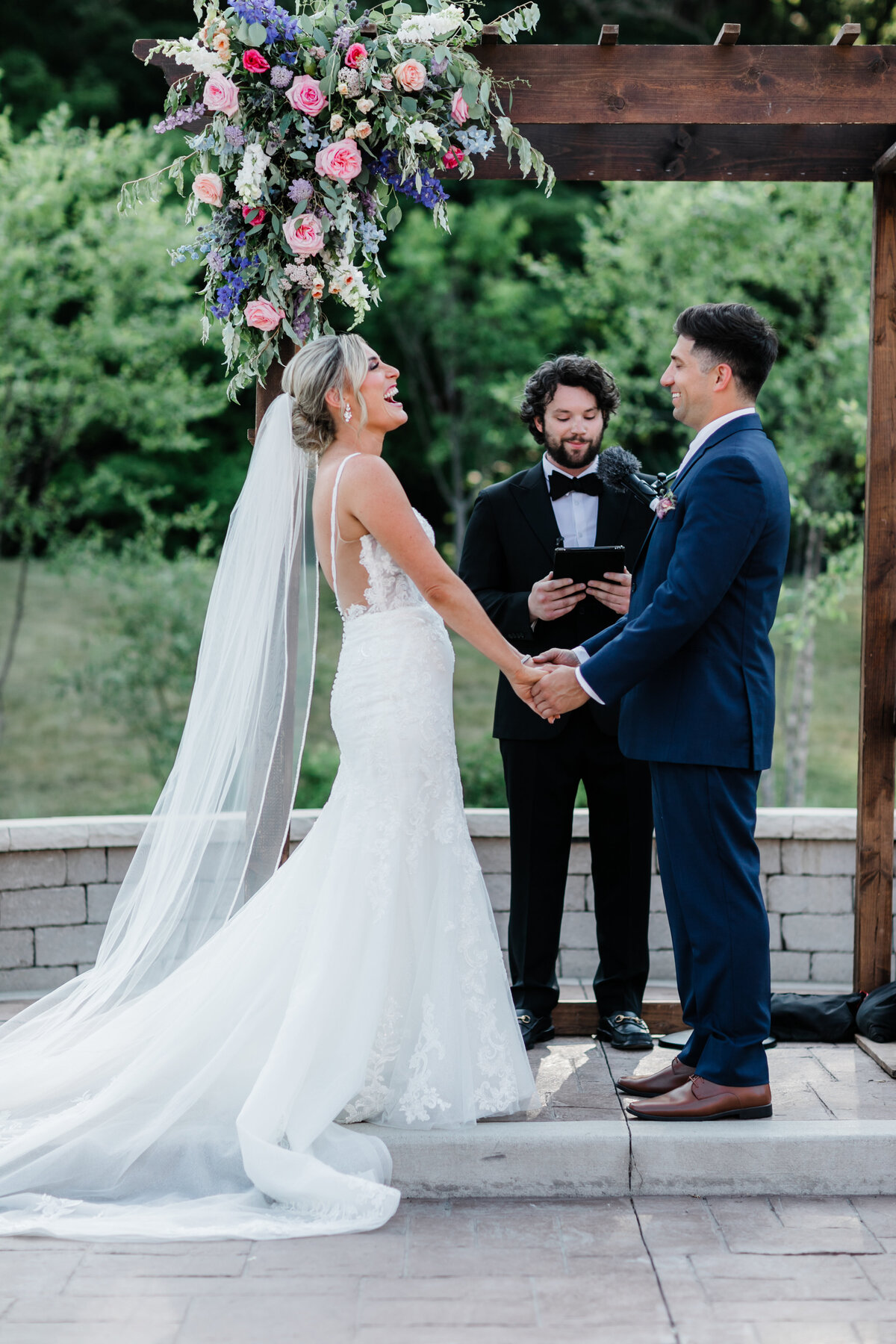 Bride and groom exchanging vows in a serene outdoor setting during their South Bend wedding.