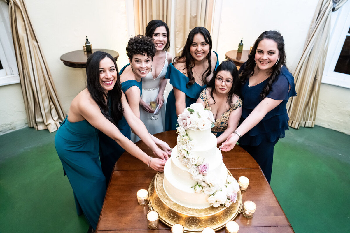Bridesmaids doing cake pulls
