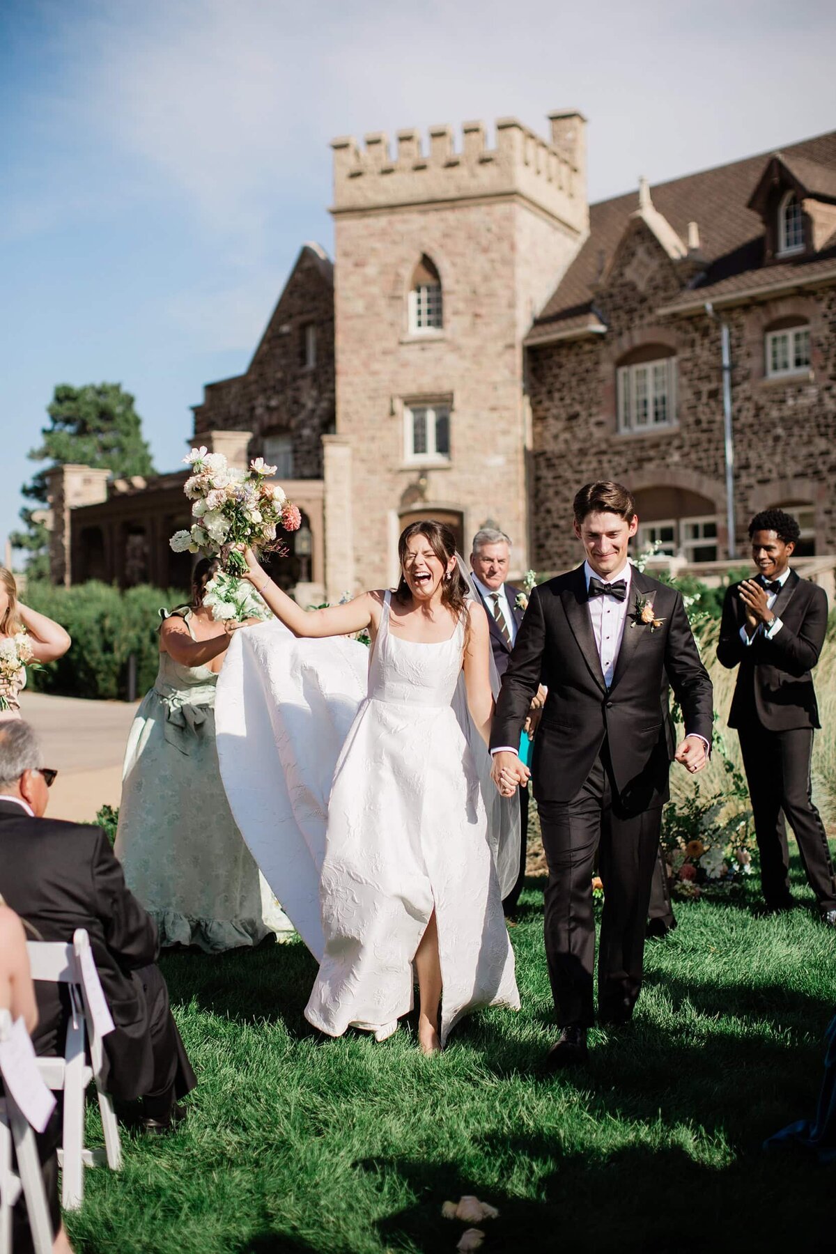 couple walking back down the aisle after wedding ceremony at highlands ranch mansion
