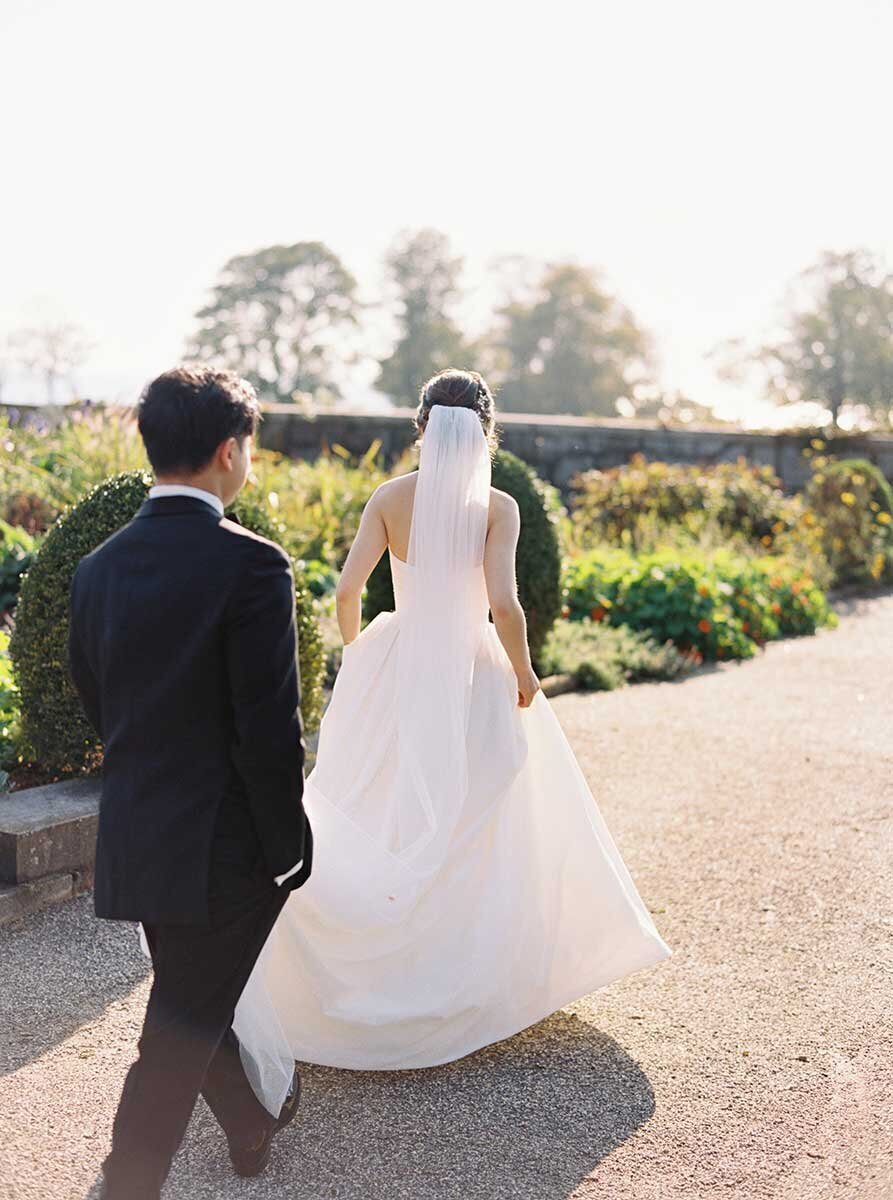Bride and groom walking in Eolia Mansion garden