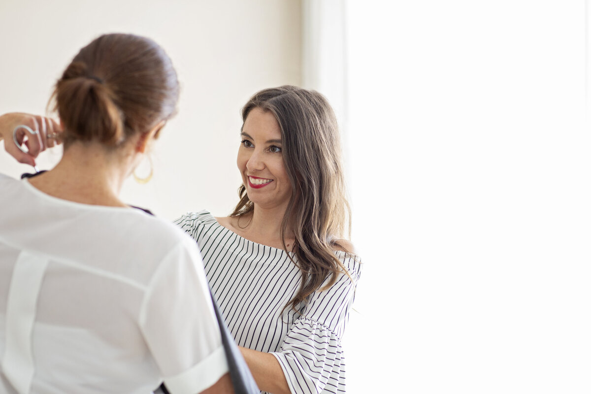 philadelphia headshots of a woman with brown hair wearing a stripped shirt talking with a client