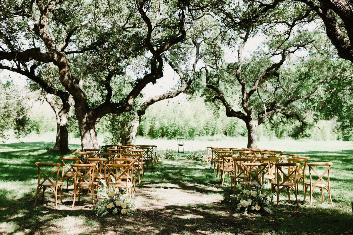 Outdoor wedding ceremony set up under the trees at  Mattie's Austin