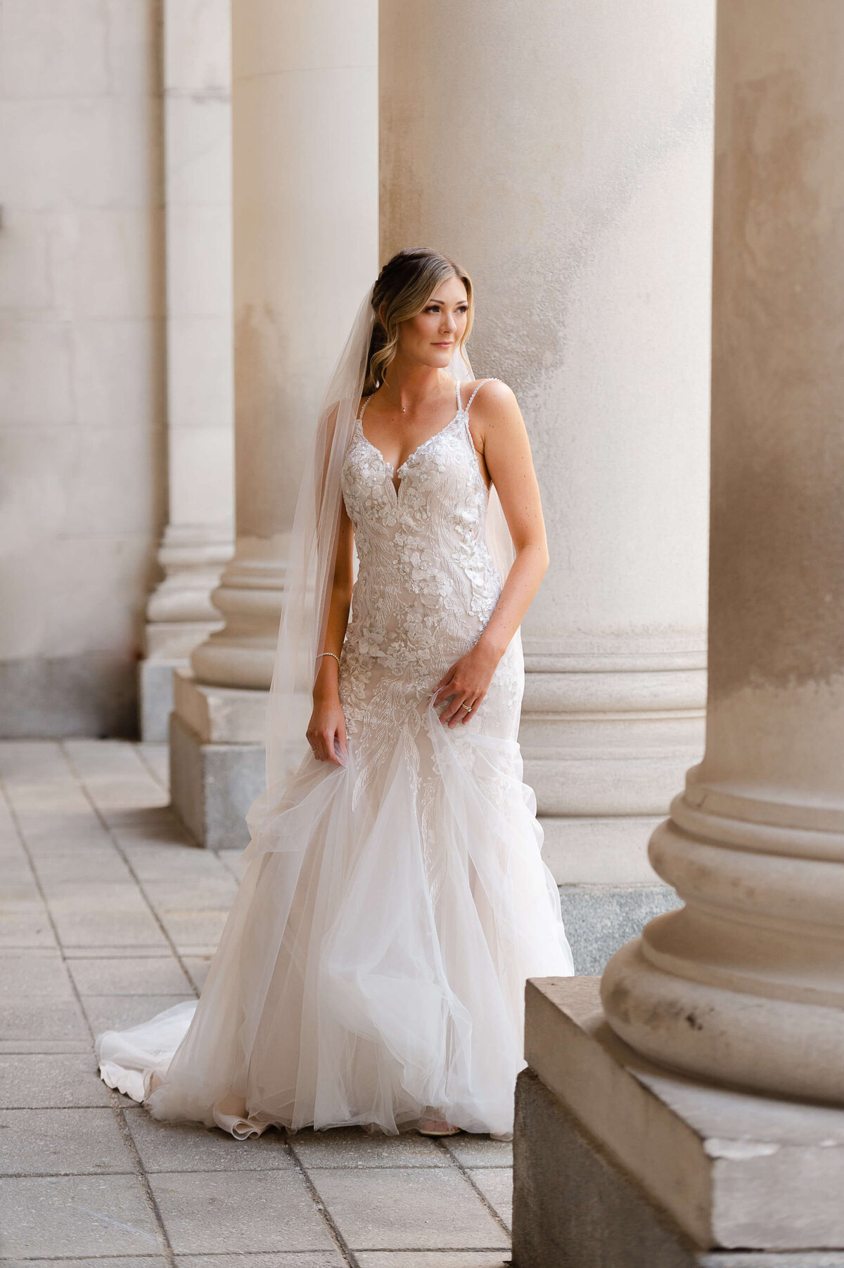 a full length photo of a bride in her gown taken outside the NAC by Ottawa wedding photographer JEMMAN Photography