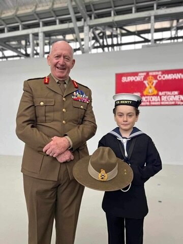 Sir Peter Cosgrove stands with local Navy cadet