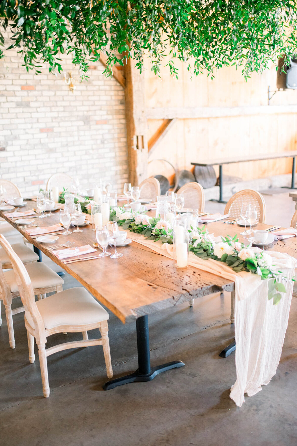 Harvest table with white runner for Toronto barn wedding