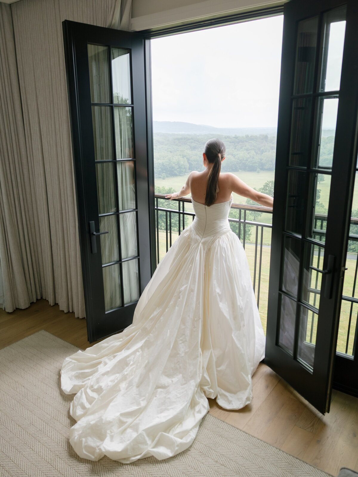 Kara in her gown looking out over the hills from the Pendry Suite balcony