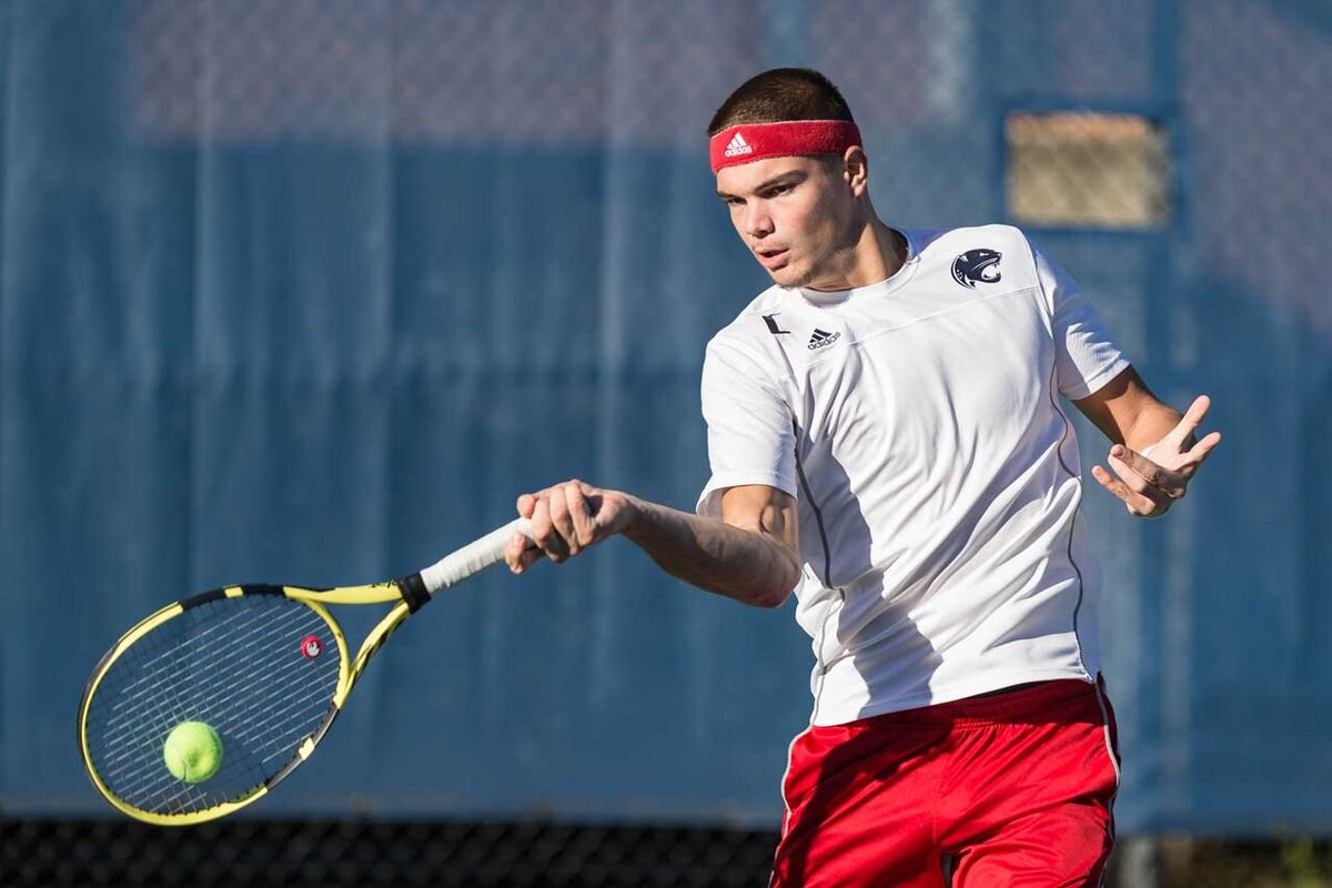Men's tennis player Loic Cloes returns a ball during a match at the David Lubel Memorial tennis courts.