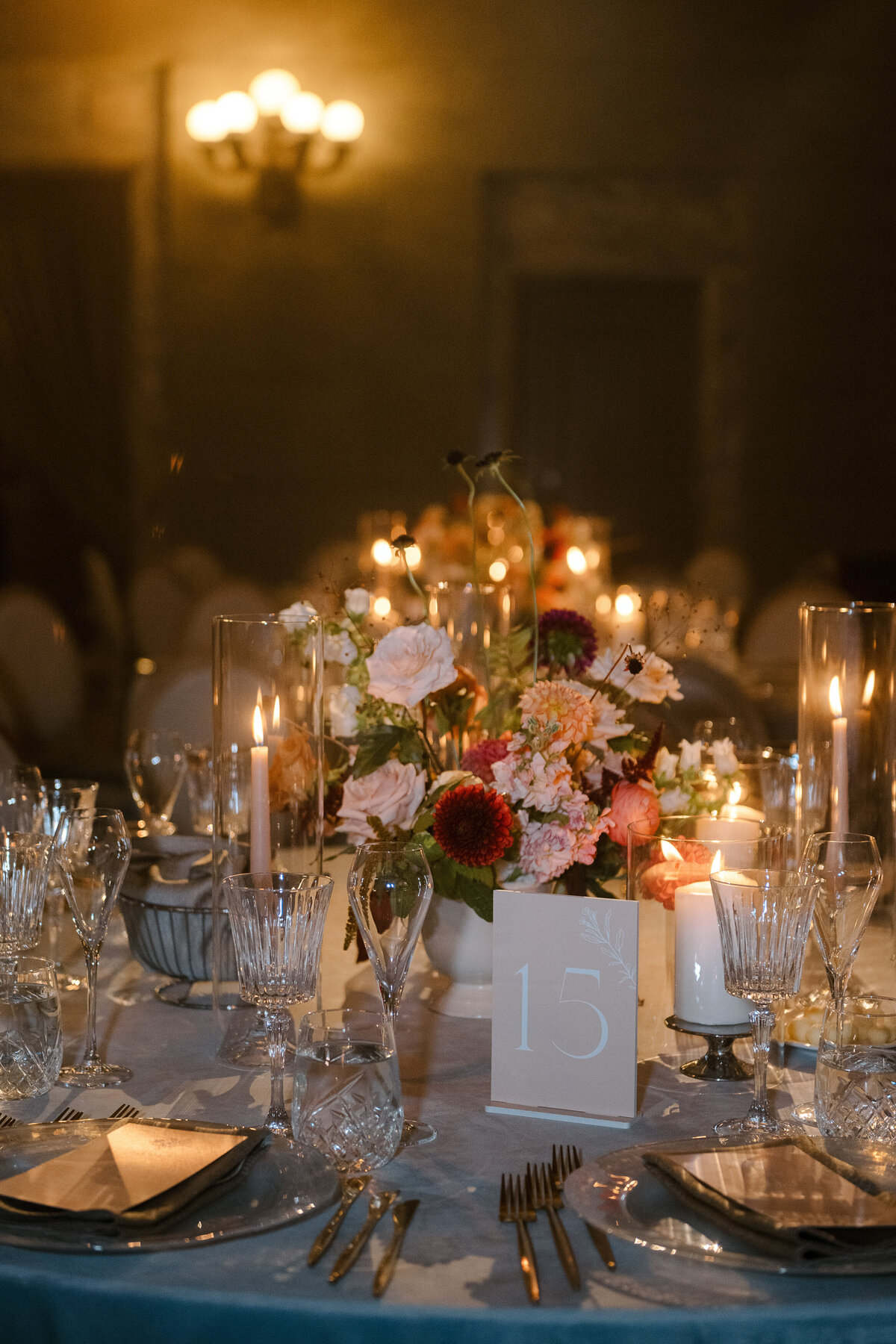 An intimate table setting at a Theatre St James wedding reception featuring a floral centrepiece.