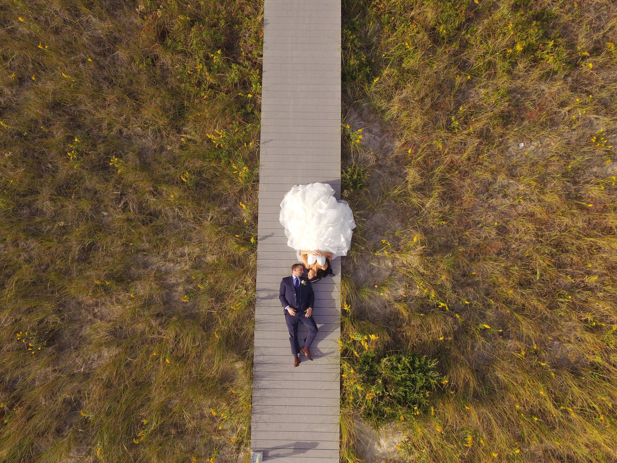 photo from above of bride and groom laying outside at Oceanbleu Westhampton