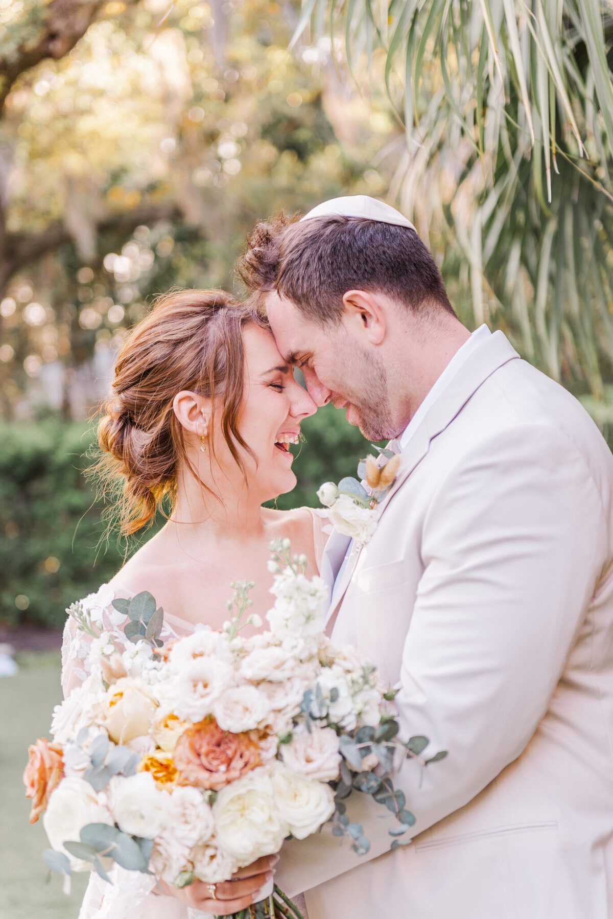 couple smiling and kissing at wrightsville manor in wilmington, nc