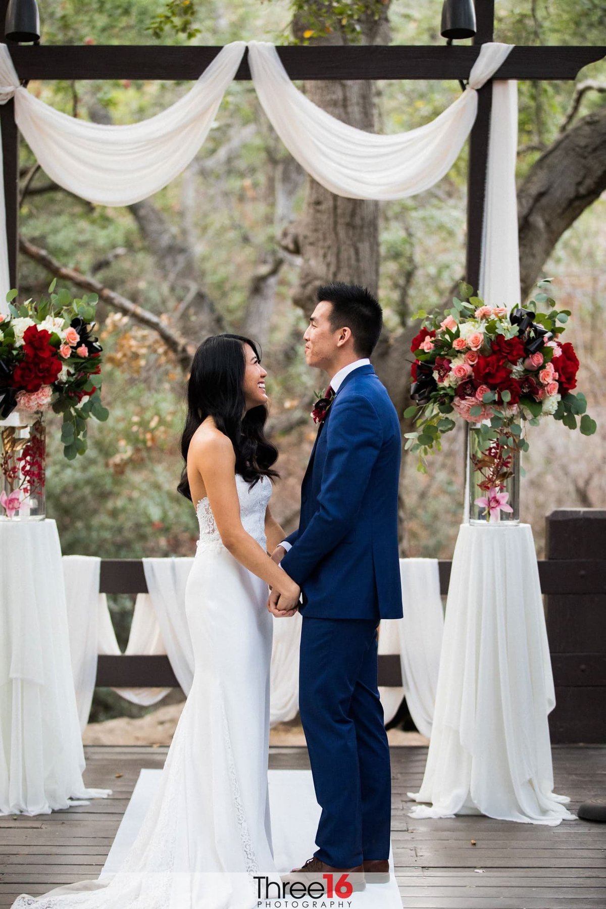 Bride and Groom are all giddy standing on the ceremony stage