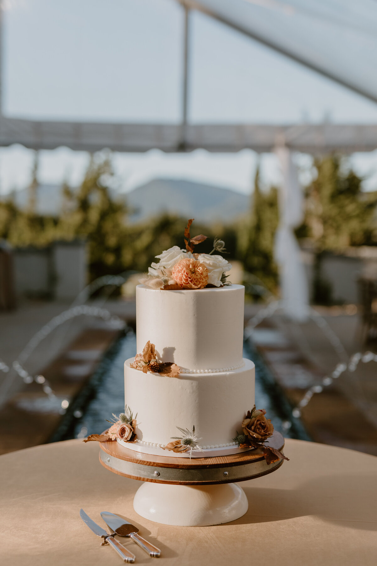 Elegant cake on display in front of Hotel Domestique’s stone walls and arches.