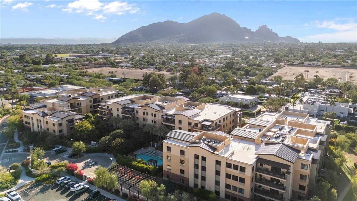 Aerial view of luxury condos and desert landscape in North Scottsdale with Camelback Mountain in the background, used on a REALTOR® page about selling your home in Scottsdale