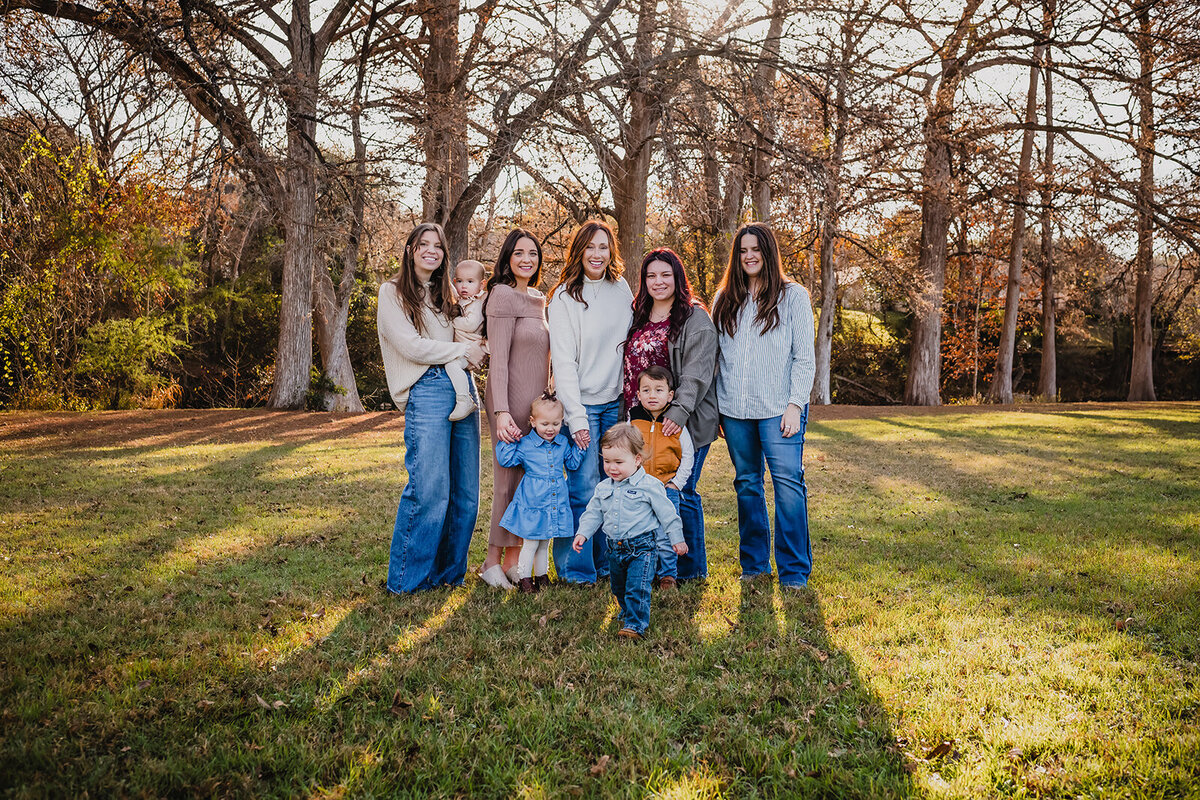 large family laughing together during sunset at Cypress Bend in New Braunfels, Texas.