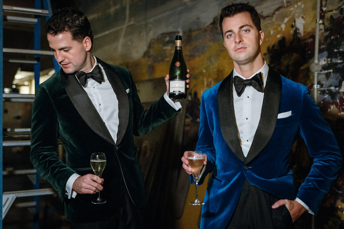 Flash photography of two grooms in their velvet suits at the backstage of Regal Cinema.