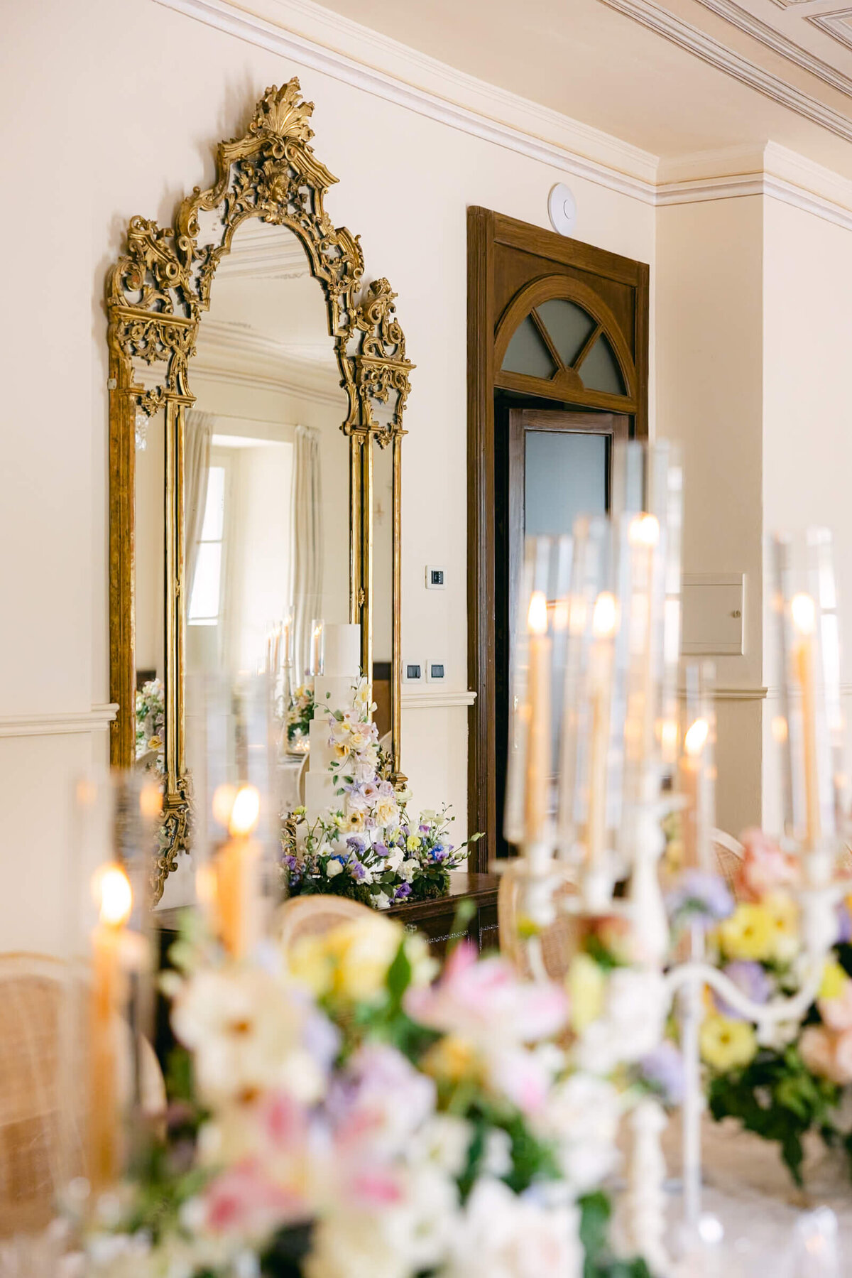 A wedding day photo of the reception cable covered in linens and candles at the wedding venue Villa Aura del Lago on Lake Como in Italy