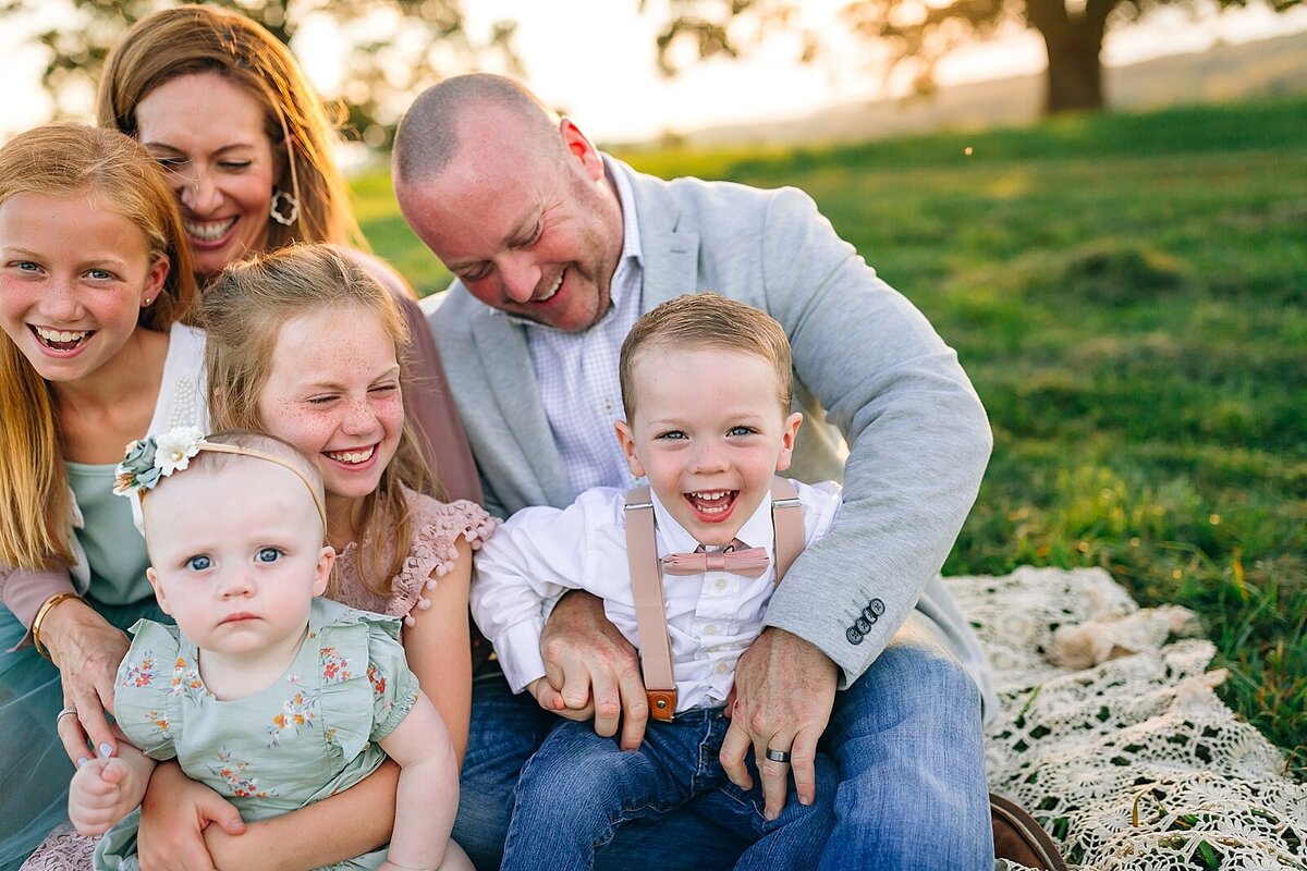 family laughing in a field in Keezletown, VA